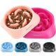 Soft peach and vibrant pink maze-style dog bowls stacked to showcase different warm color tones.