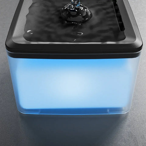 Automatic pet water fountain with glowing blue LED water level indicator.