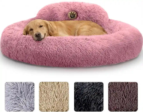 Golden retriever sleeping peacefully in a large plush pink calming donut dog bed