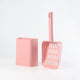 Pink cat litter scoop and its container on white background view.