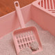 Pink litter scoop with ergonomic handle and fine mesh for clump removal.