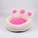 Pink paw-shaped pet bed on a white background.