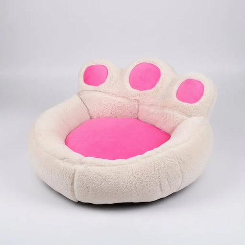 Pink paw-shaped pet bed on a white background.