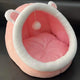 Pink pet bed with white rim and ears on black background.
