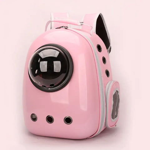 Pink pet carrier with a transparent dome on light pink background.