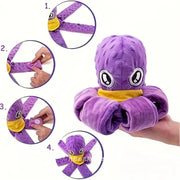 Purple plush octopus toy with yellow accents held by a hand on white background