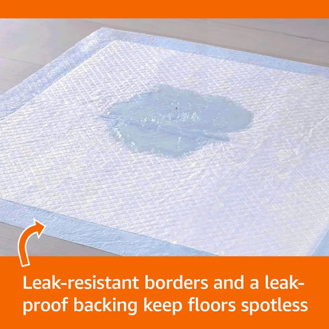 Close-up of liquid absorbing into a quilted leak-resistant puppy pad with leak-proof border