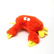 Red plush crab-shaped dog toy on a white background, soft and durable
