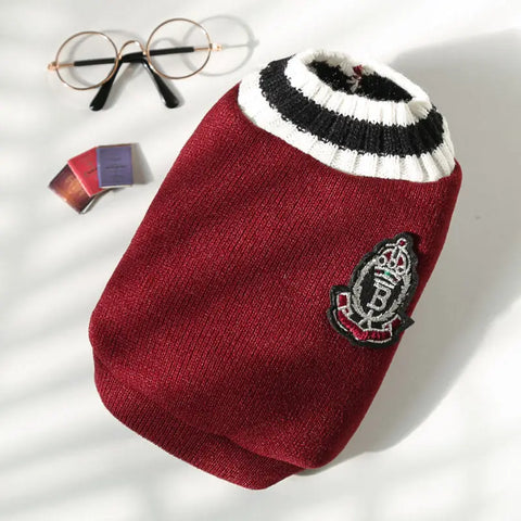 Red sweater with a logo on white background.