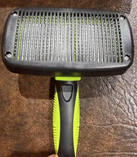 Side view showing the stainless steel bristles retracted into the brush head for safe storage and easy cleaning.