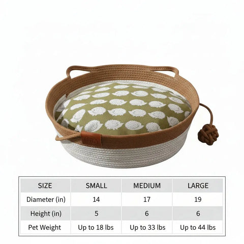 Round pet bed with floral pattern and brown handle on gray background.