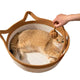 Round woven nest with soft cushion and rope handles for cats.