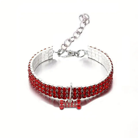 Silver bracelet with red gemstones on a white background.