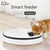 Smart feeder with a dog interacting with it on a tiled floor, featuring the Elite brand