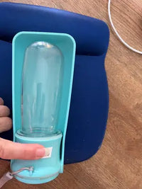 Customer review photo of a lake blue 12 oz Soicta portable pet water bottle resting folded on a pad