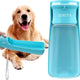 Blue portable dog water bottle dispenser held out for a Golden Retriever