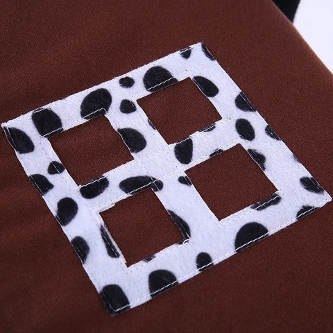 Square patch with black and white pattern on brown background.