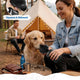 Woman squeezing a flexible, squeeze-and-rebound dog water bottle for her golden retriever