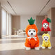 Three small dogs wearing costumes resembling carrot, apple, banana.