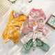 Two plush pet outfits, yellow and pink with green accents.