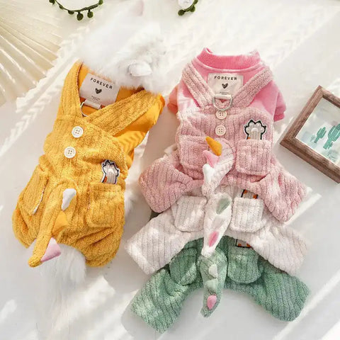 Two plush pet outfits, yellow and pink with green accents.