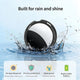 Waterproof smart tracker splashing in water with a replaceable battery icon.