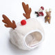 White pet bed with reindeer antlers and red nose on white background