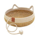 Woven pet bed with rope handles and decorative rope tie on white.
