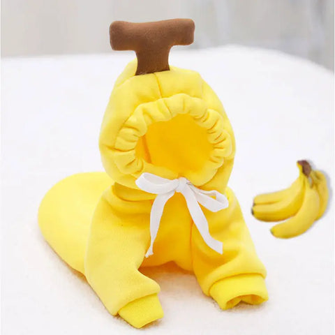 Yellow banana-themed baby outfit with brown handle on white.