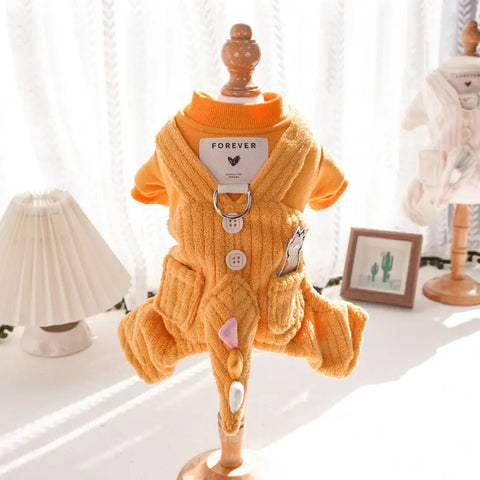 Yellow dog outfit with buttons and heart design on mannequin.