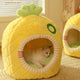 Yellow pineapple-shaped pet bed with a cat inside on textured surface.